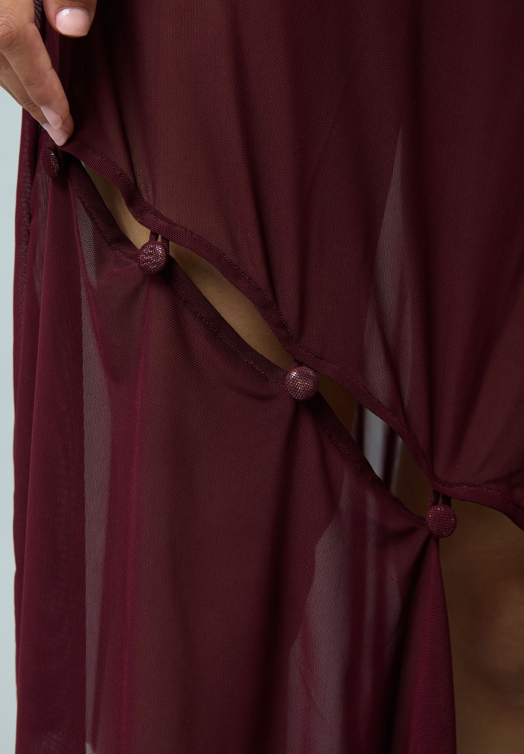 ASYMMETRIC MESH SKIRT WITH FLOWER APPLIQUE
